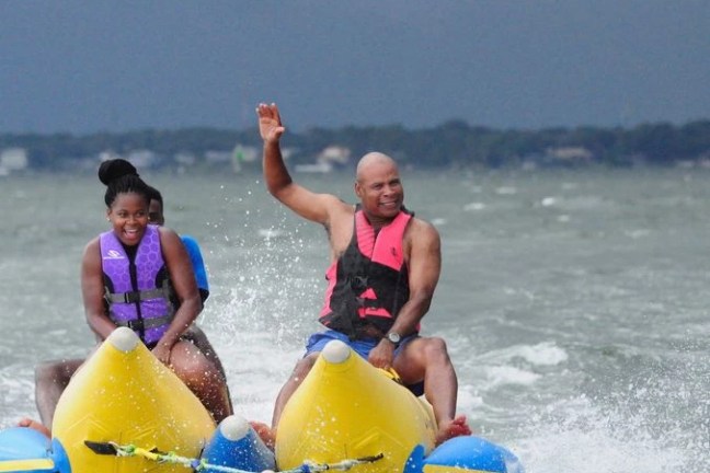 a young girl riding a wave on a surfboard in the water
