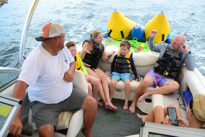 a group of people sitting on a boat