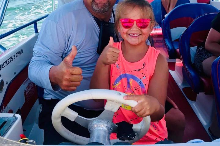 a group of people sitting on a boat in the water