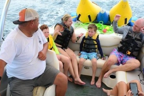 a group of people sitting on a boat