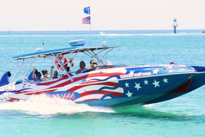 a small boat in a body of water next to the ocean