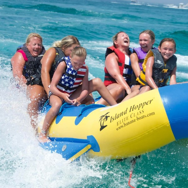 a group of people standing next to a body of water