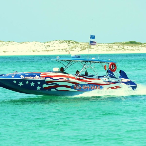 a small boat in a body of water next to the ocean